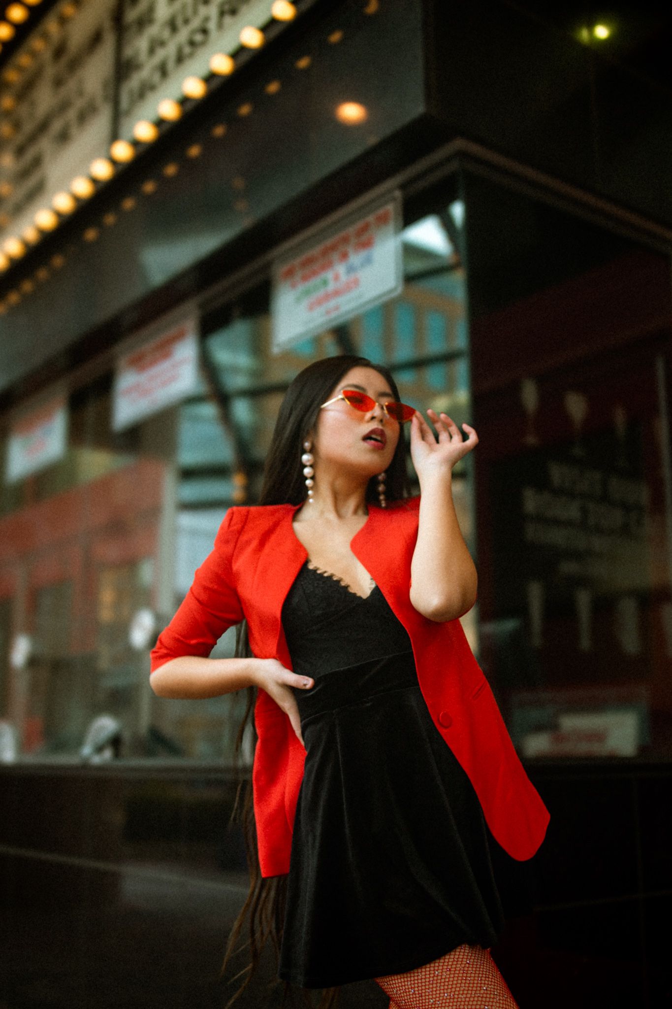 Valentine’s Day creative photograph of woman in front of a movie theater.