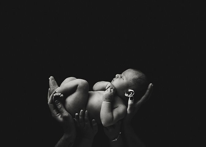 Artistic black and white silhouette series of a newborn baby.
