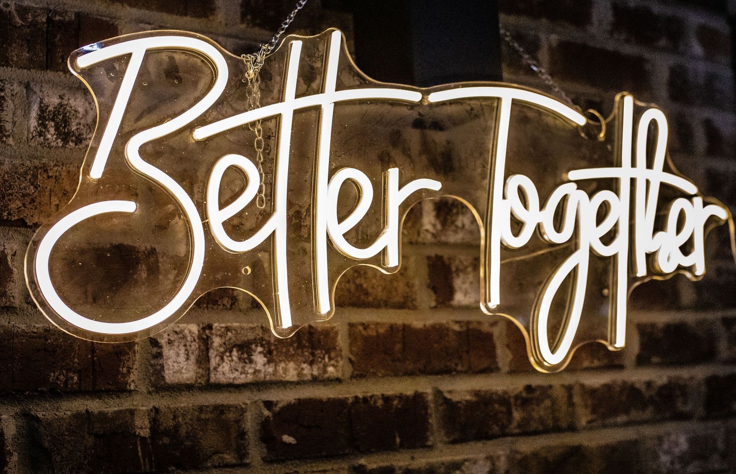 White graffiti text sprayed on a dark wall creates an urban street art design.