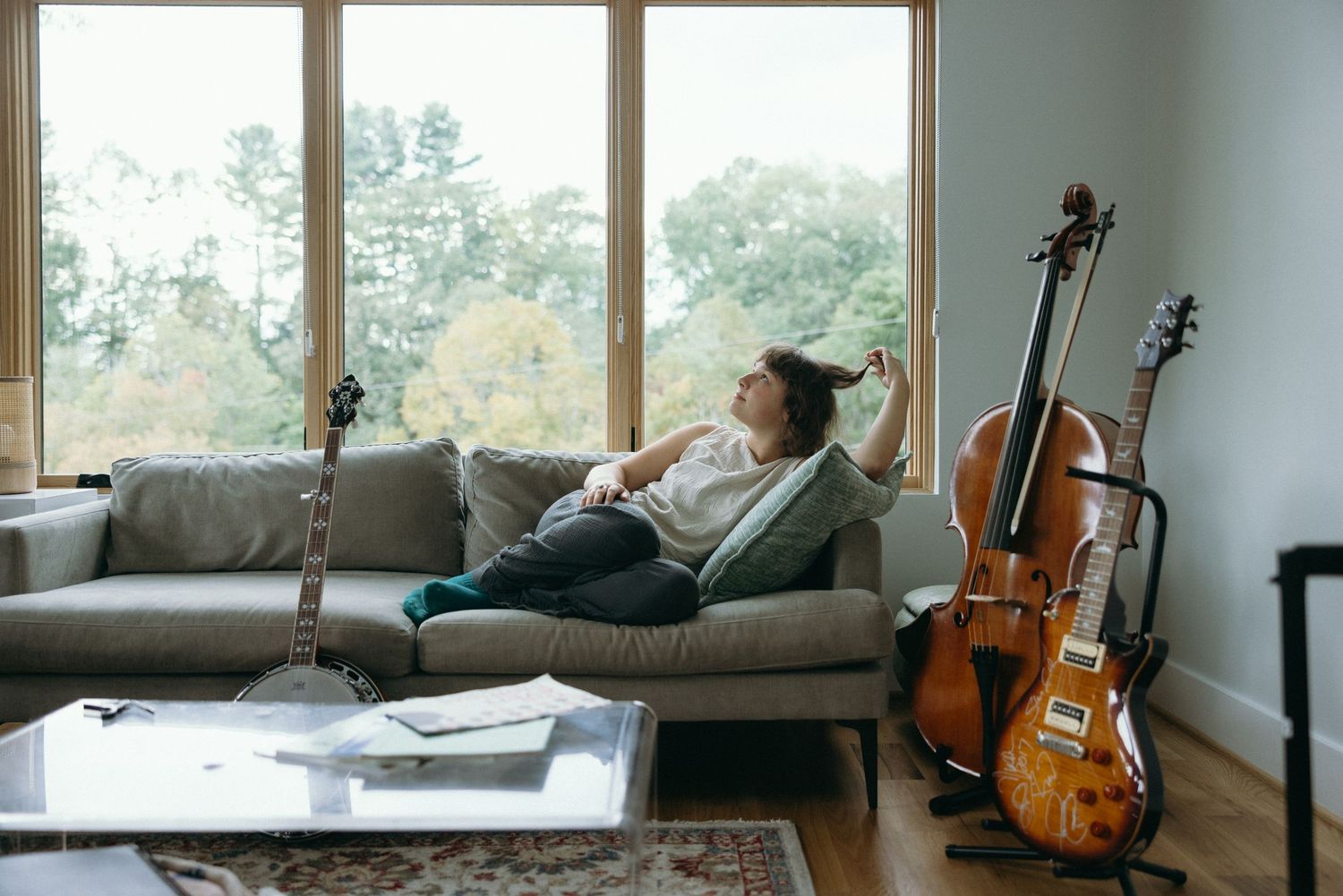 A panoramic sequence of living room views showing a guitar, couch, and window overlooking a scenic landscape.