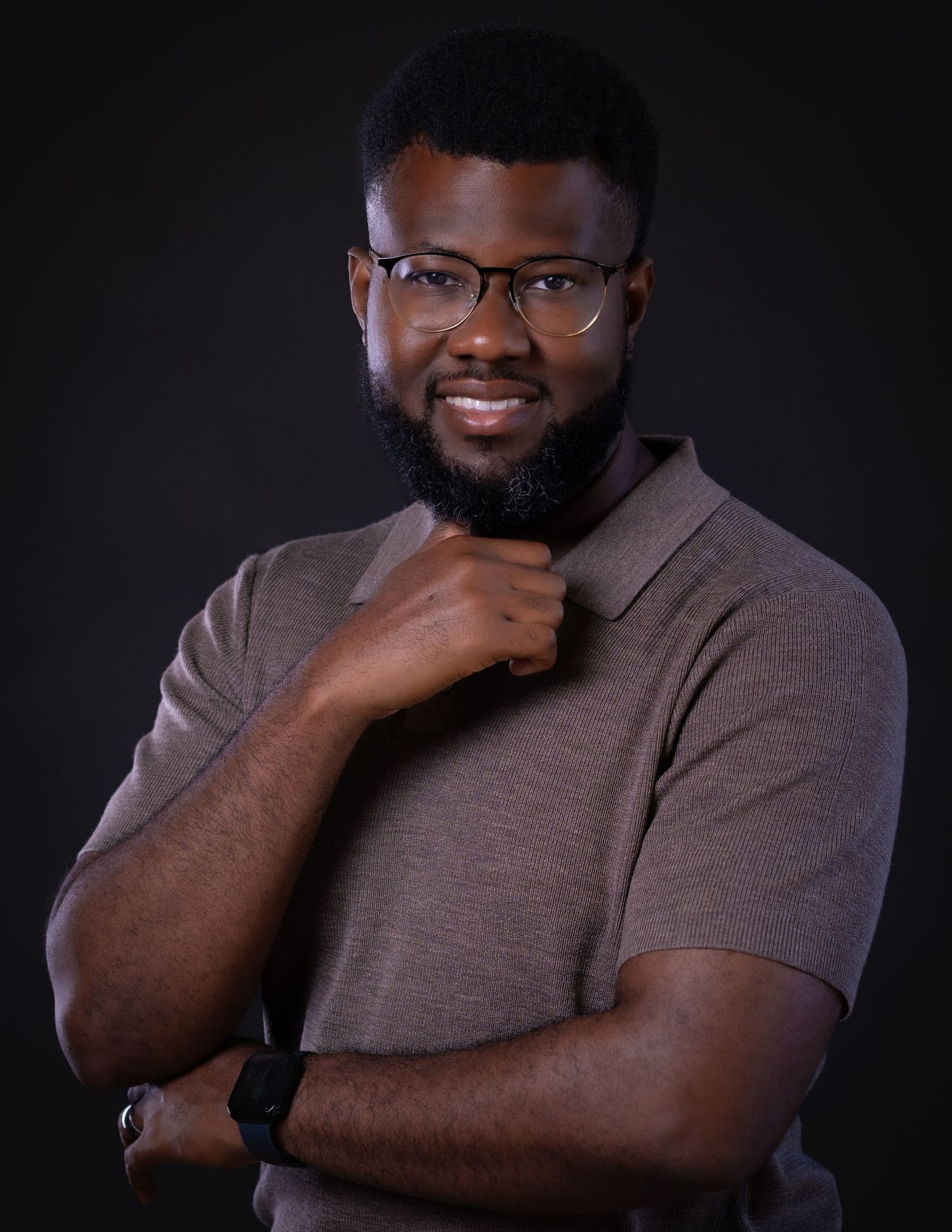 Portrait series showing a person in glasses and brown shirt against dark background making thoughtful expressions.