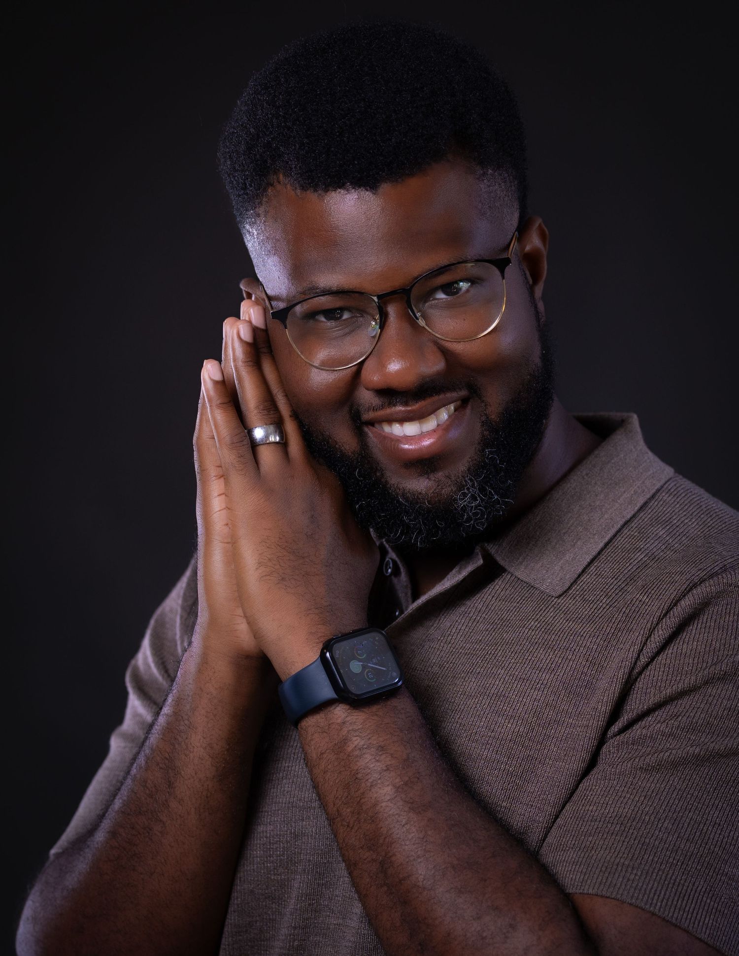 A series of expressive studio portraits showing a person in a dark brown shirt against a black background.