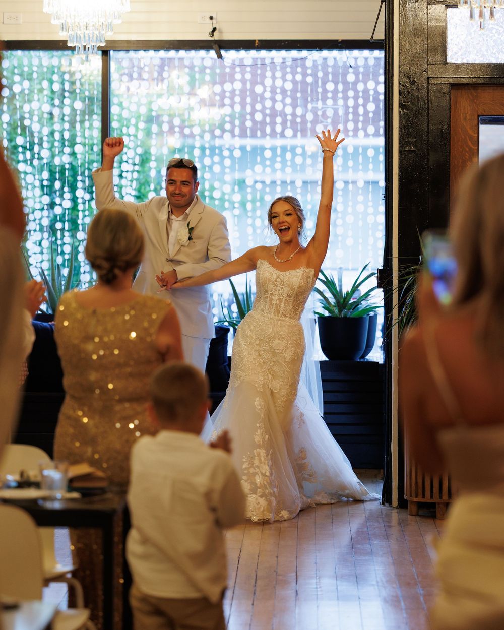 Wedding reception dance party with twinkle lights and guests celebrating on the dance floor.