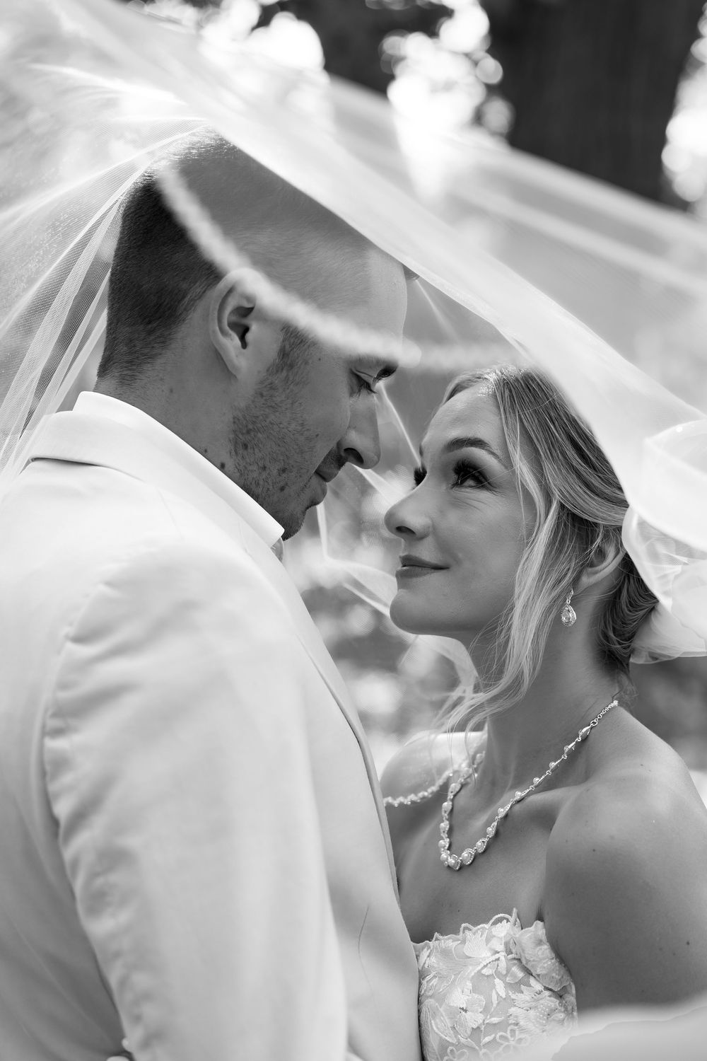 Romantic black and white close-up shots of a couple sharing intimate moments during their wedding day.