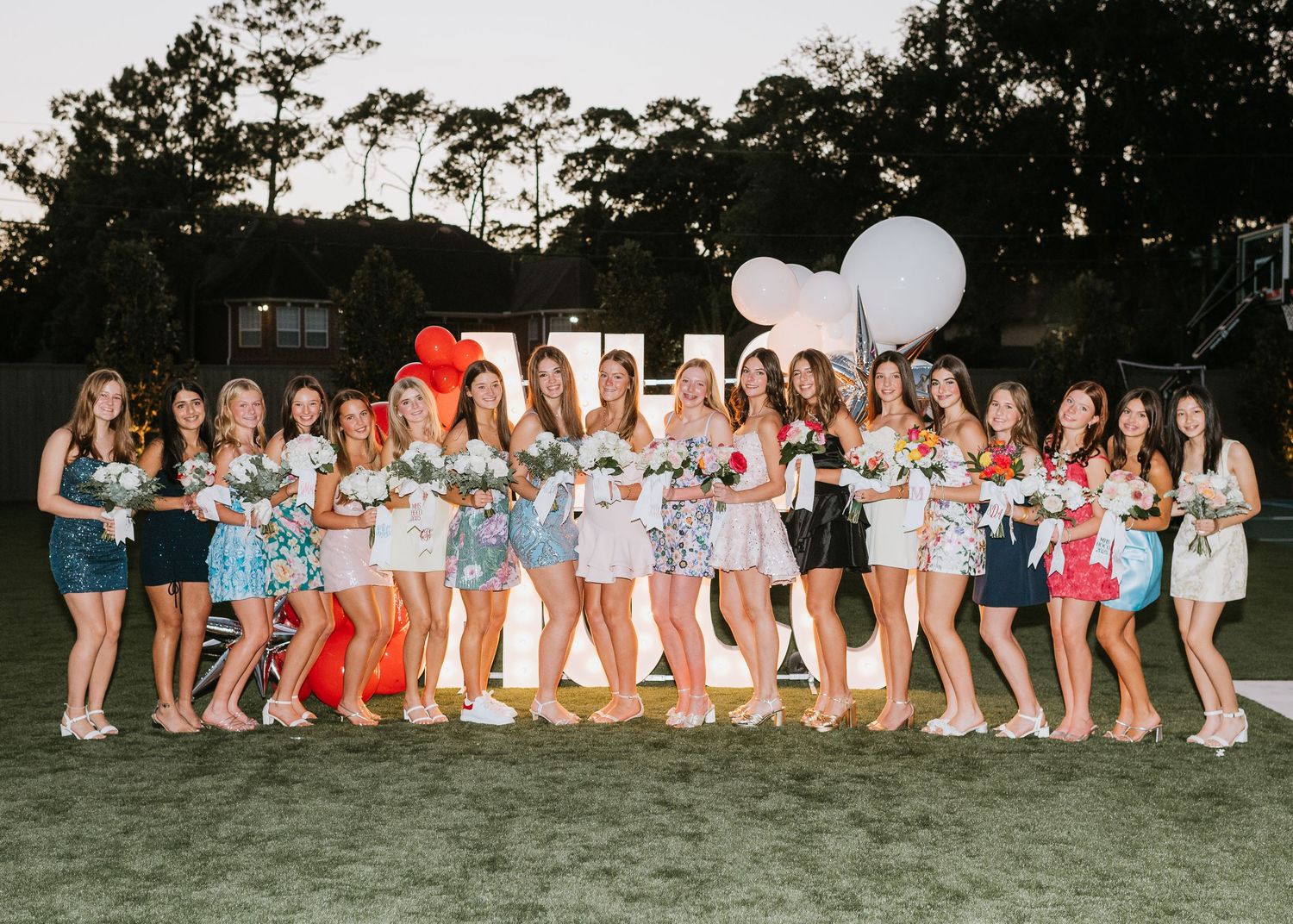 Group of teens smiling in elegant formal attire at a homecoming party for high school in Houston Texas.