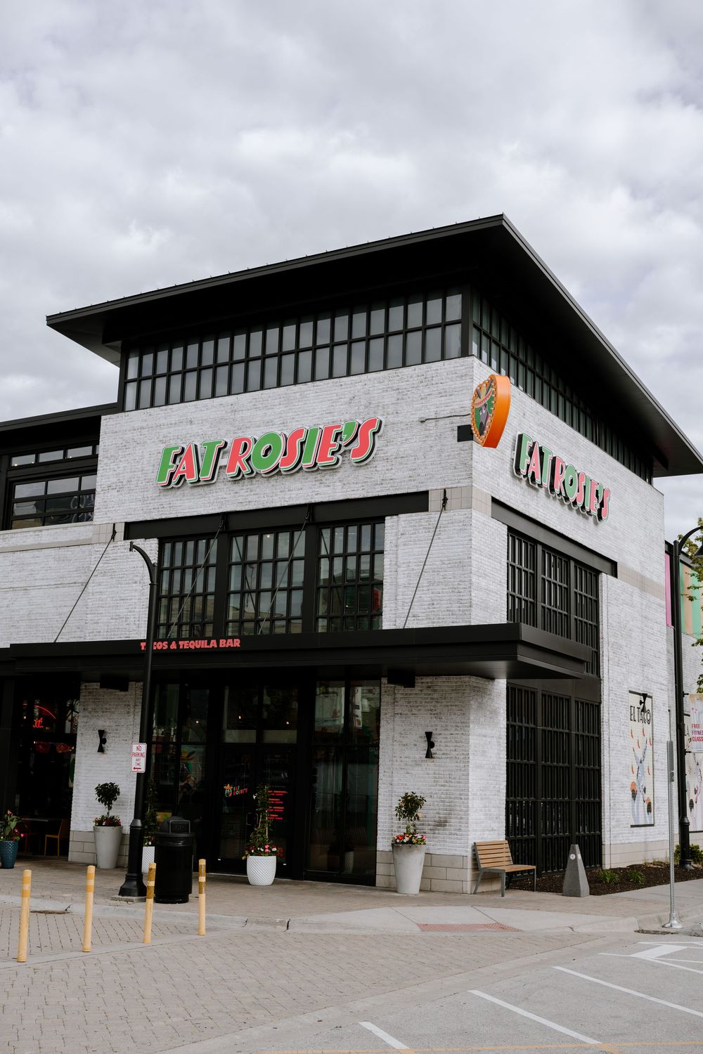 Modern commercial building exterior with white stone facade and large glass windows displaying Fry's Foods signage.