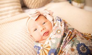 A collage of six baby photos showing a sleeping infant in various poses on soft blankets and fabrics.
