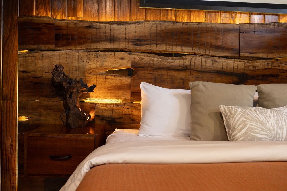 Close-up of luxurious bedding and pillows in wooden cabin bedroom.