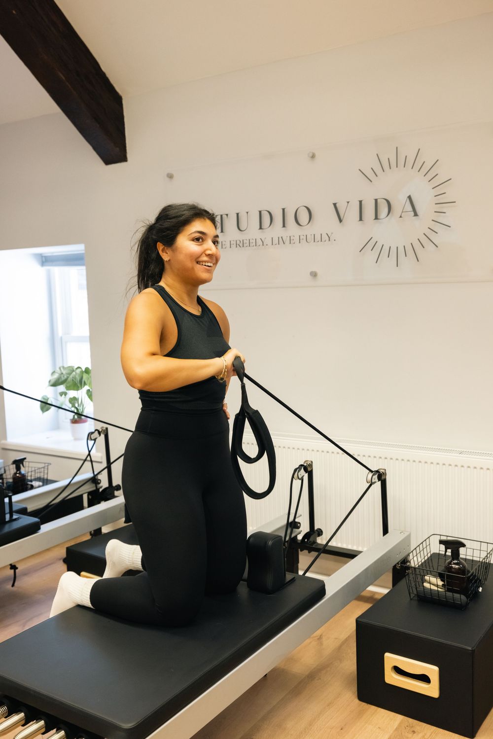 Fitness instruction session on pilates reformer equipment at Studio Vida wellness center.