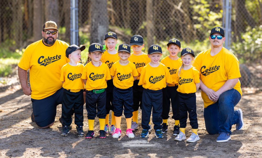 Youth baseball team in bright yellow Celeste uniforms posing together on field.