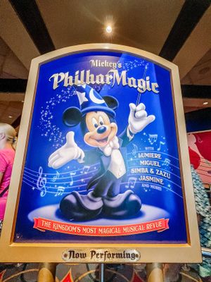 A promotional poster for Mickey's PhilharMagic musical show featuring Mickey Mouse in a blue magical design with music notes.