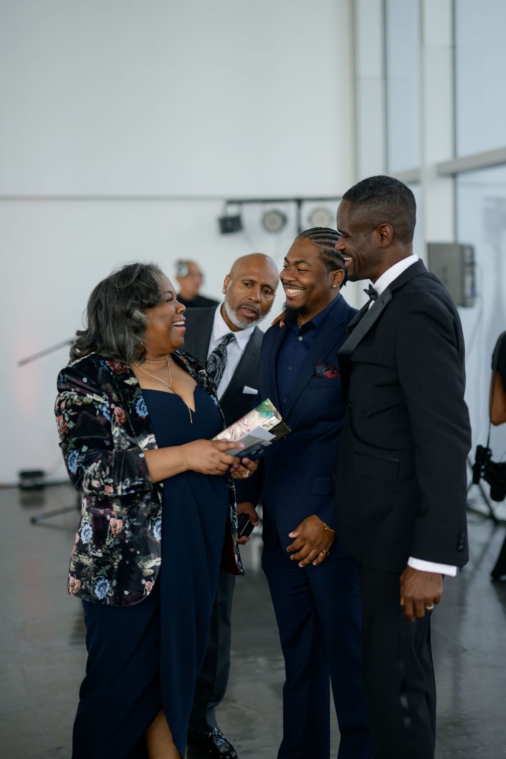 A group of guests sharing a joyful moment at an elegant indoor event.