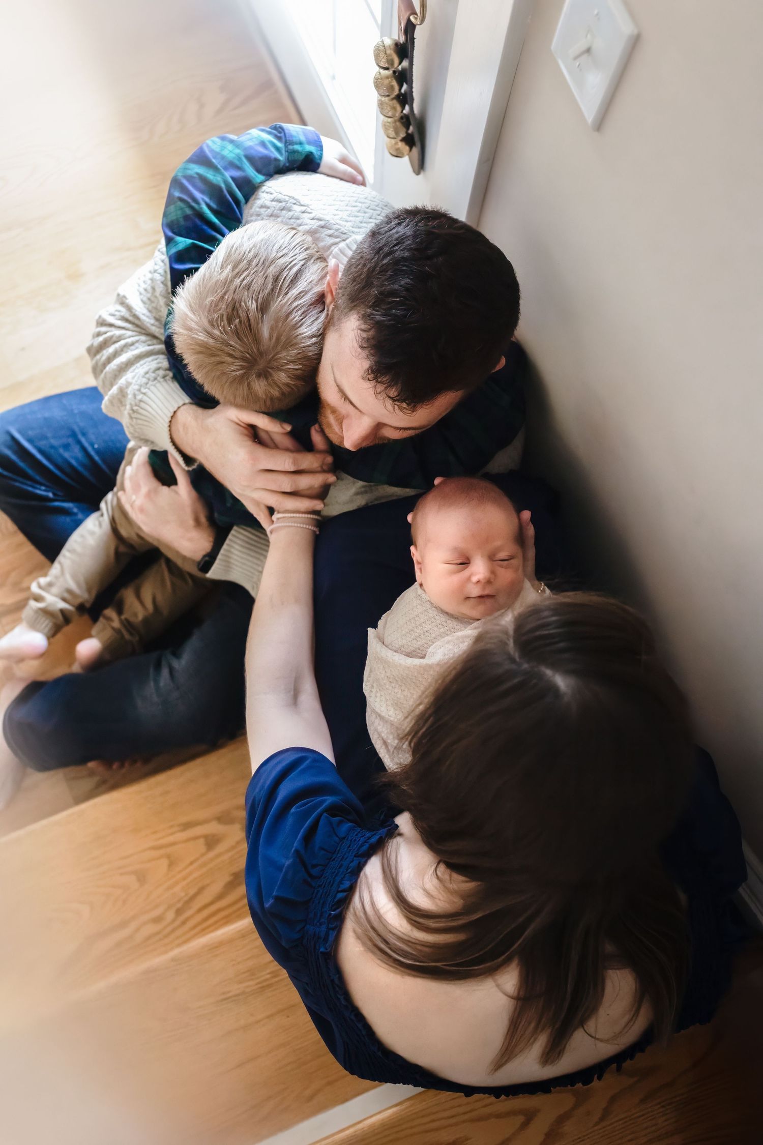 Charlottesville photographer, newborn, family, lifestyle session with family holding hands and snuggling.