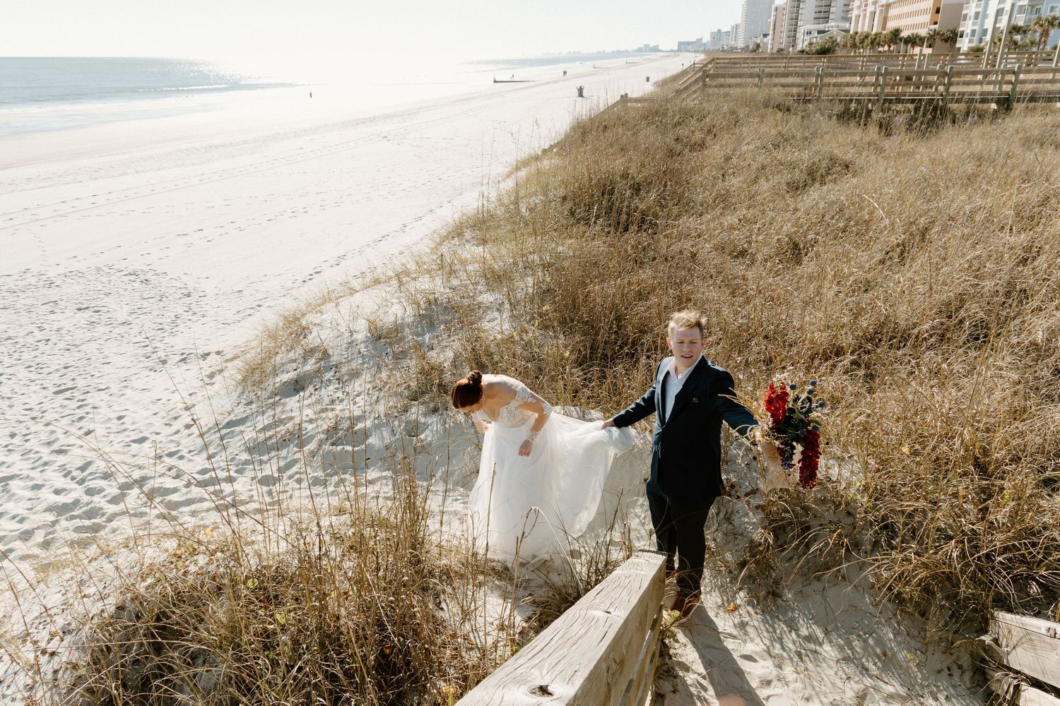 A bride and groom share an intimate moment along a dramatic Pacific Northwest coastline during their wedding.