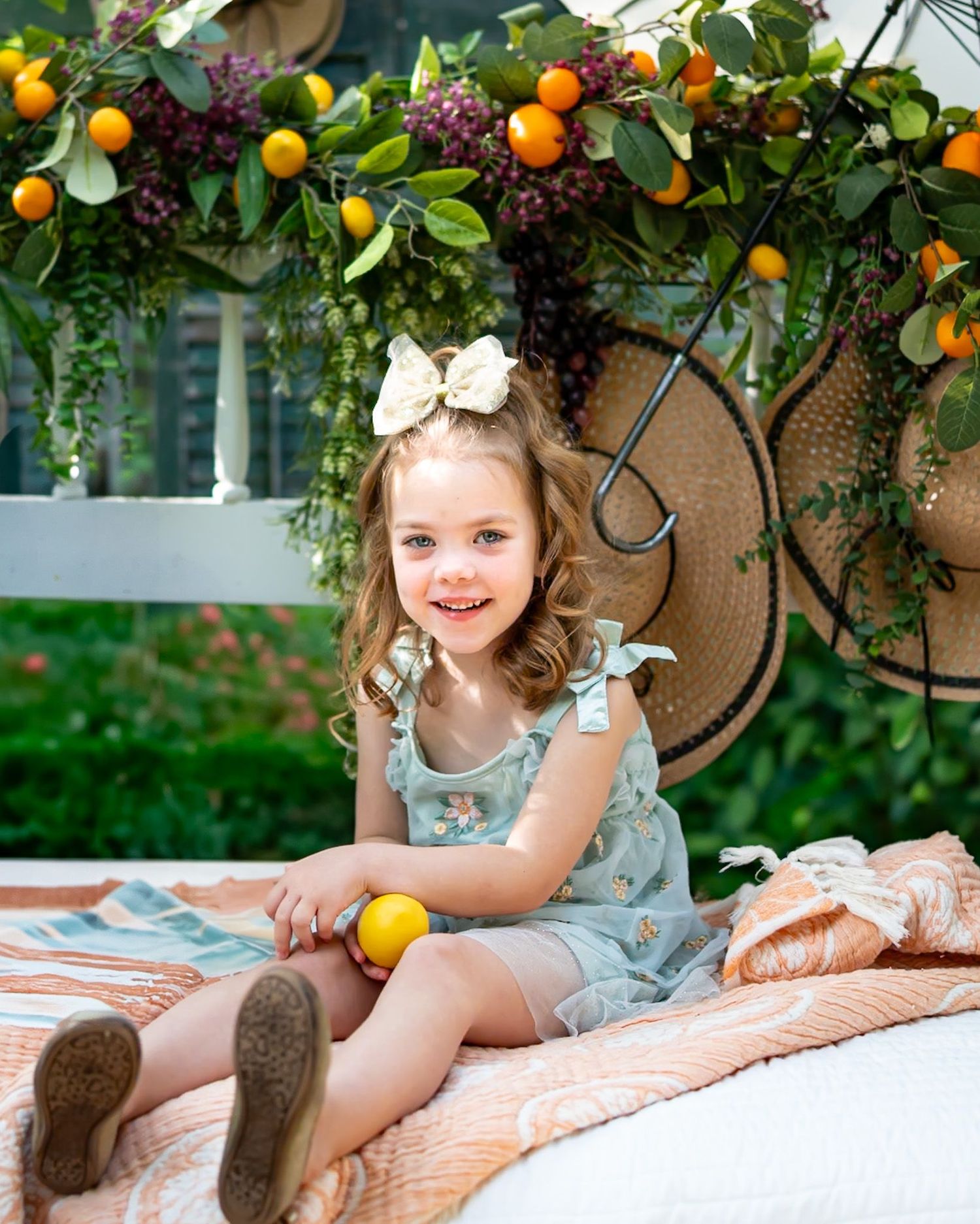 Citrus and floral decorated garden setting with vintage furniture and soft textiles.