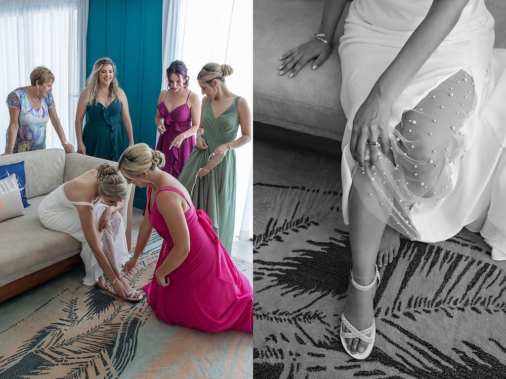 A group gathers around a sofa while someone arranges a decorative palm frond pattern on the floor.
