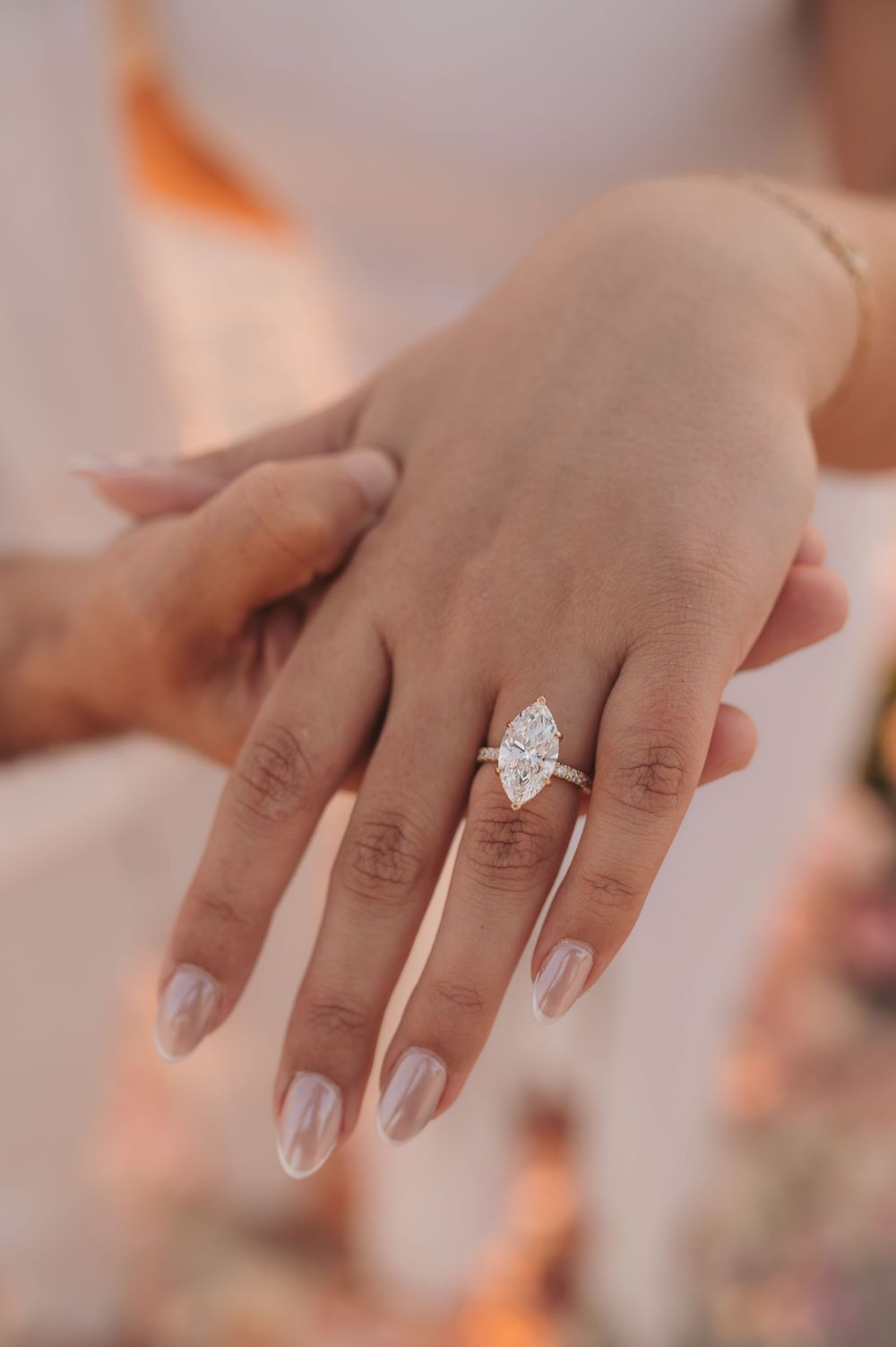Close-up of engagement ring during a beach proposal photography session