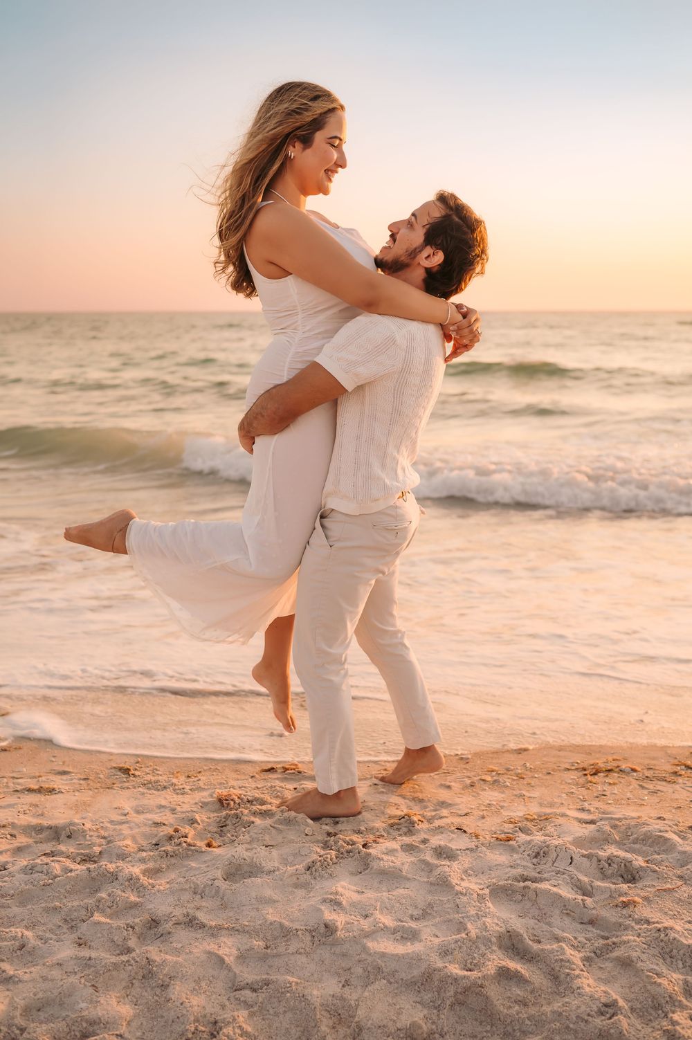 Couple reacting with joy after a surprise sunset engagement session