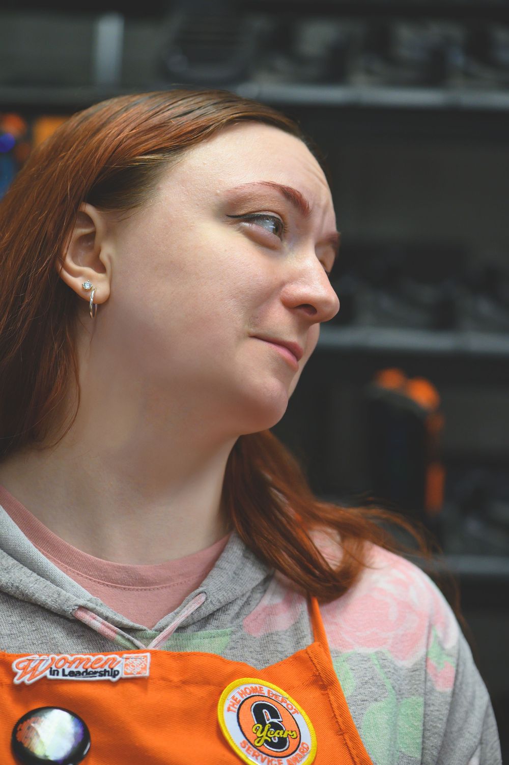 A series of profile-view portrait photos showing someone with red hair wearing a casual orange and gray outfit.
