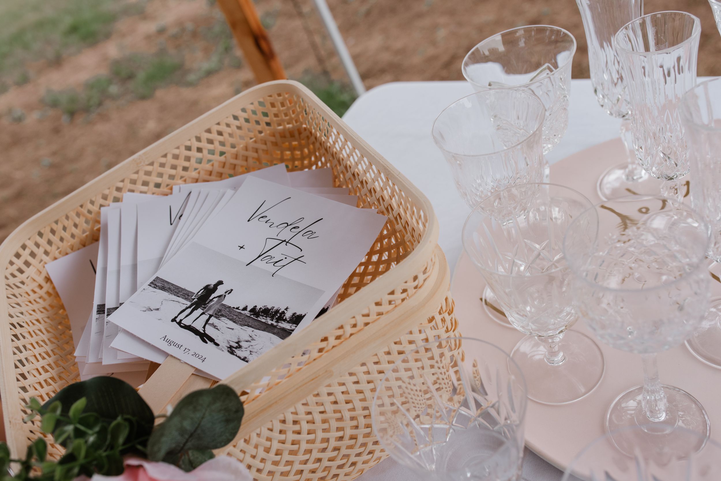 Place settings at an elegant wedding reception with woven placemats and crystal glassware.