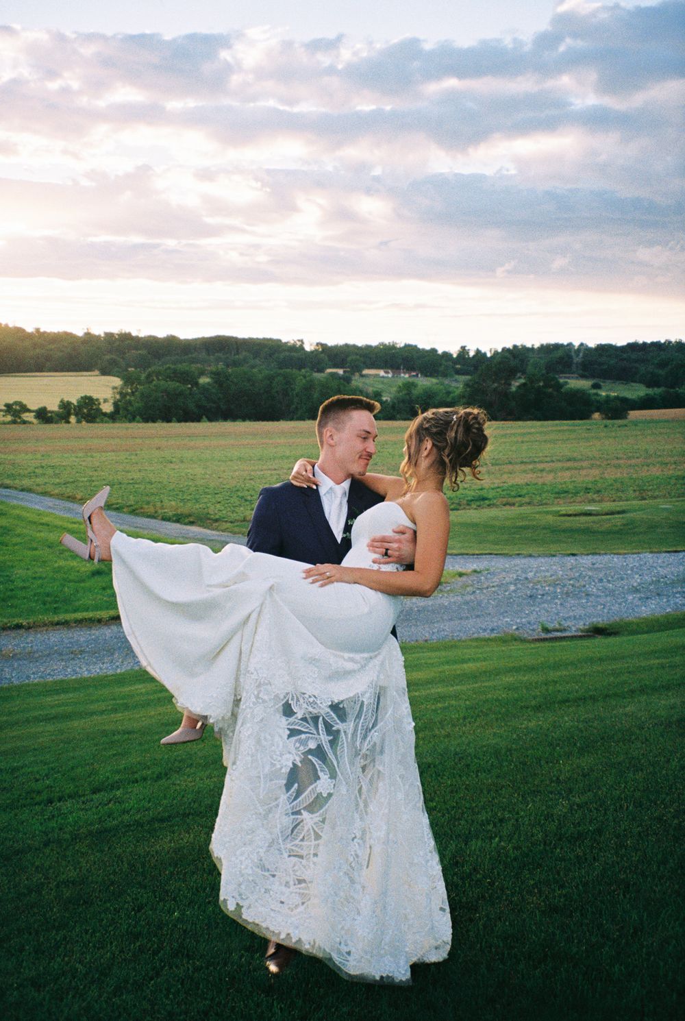 A dramatic wedding photo sequence showing a groom dipping his bride in a white dress against a sunset field.