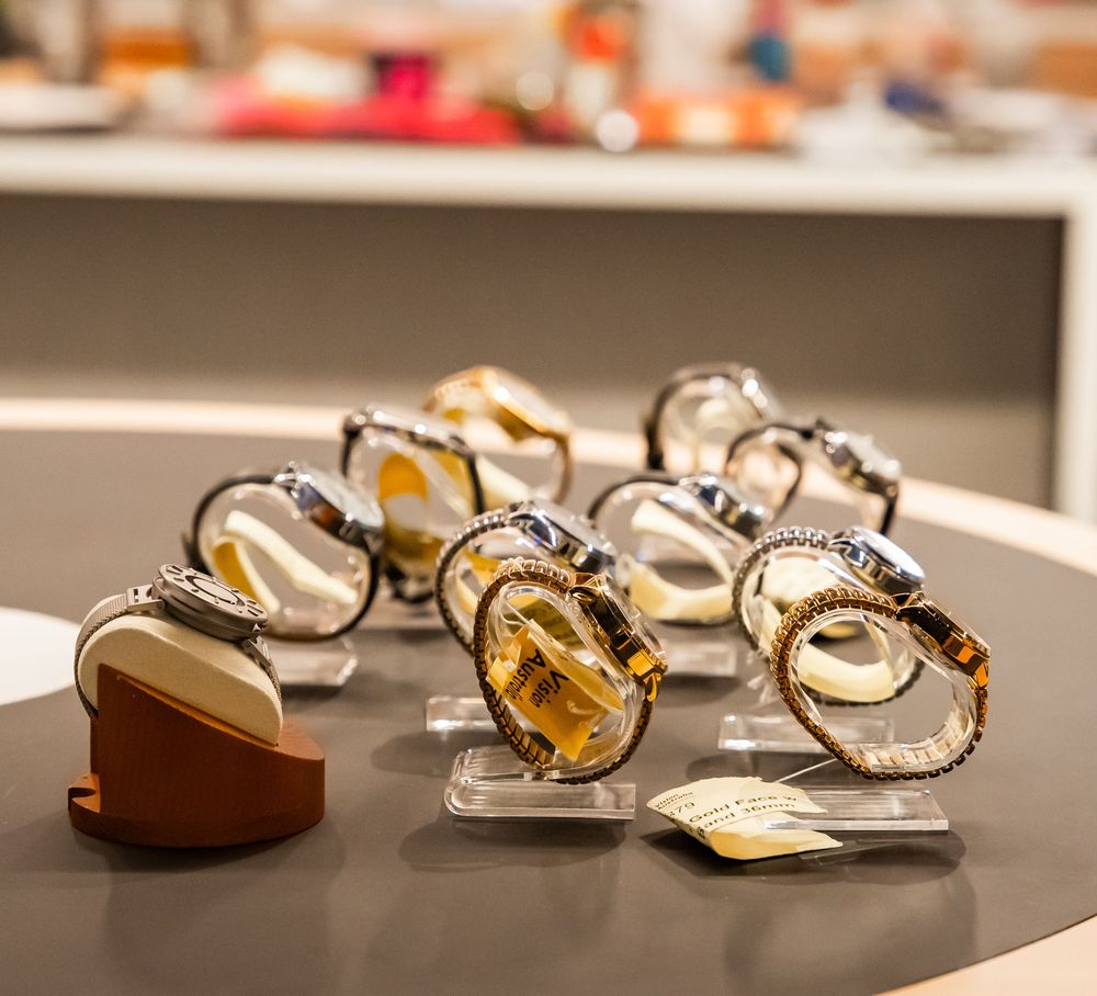 Gold and pearl jewelry pieces displayed in a row on a dark surface, showing their elegant craftsmanship and design.
