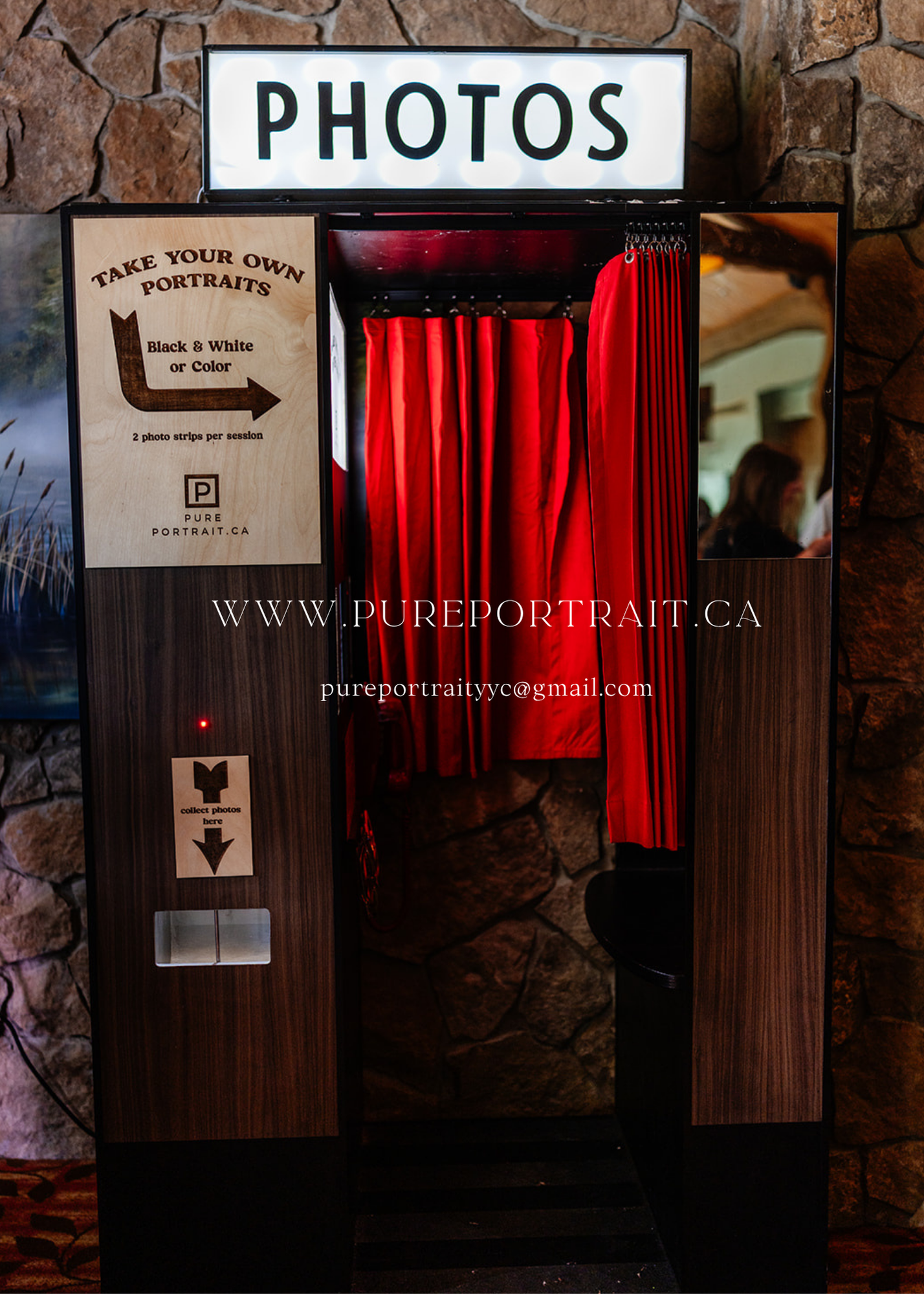 Vintage photo booth entrance with red curtains and stone wall backdrop displaying signage for portrait photography services.