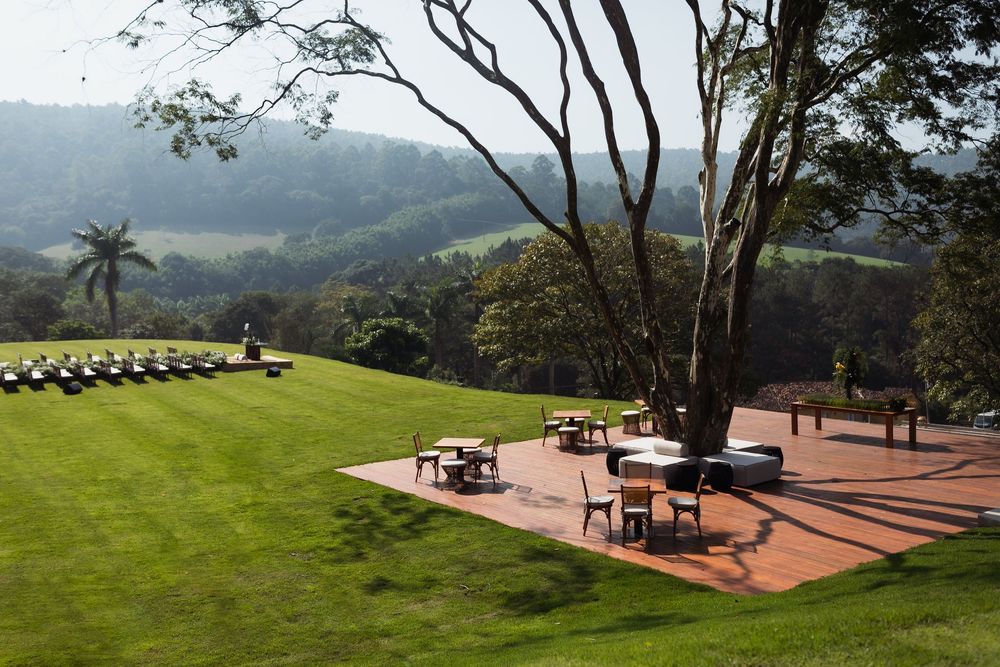Panoramic view of a hilltop wedding venue with terracotta patio and scenic mountain vistas.