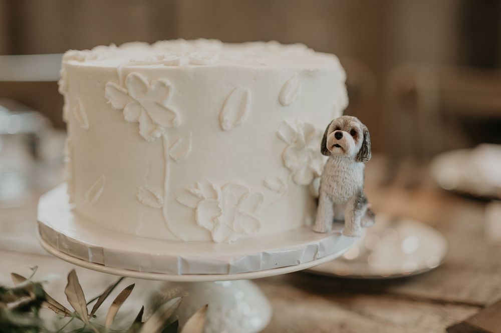 Close-up detail of an elegant white wedding cake with delicate floral decorations.