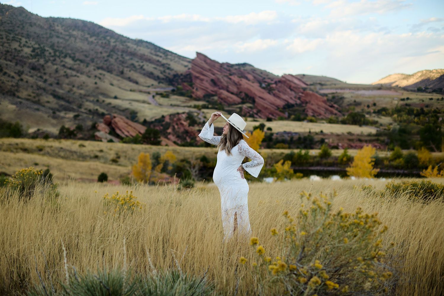 Maternity photo of expectant mother in lace dress at Mt Falcon East Denver Colorado