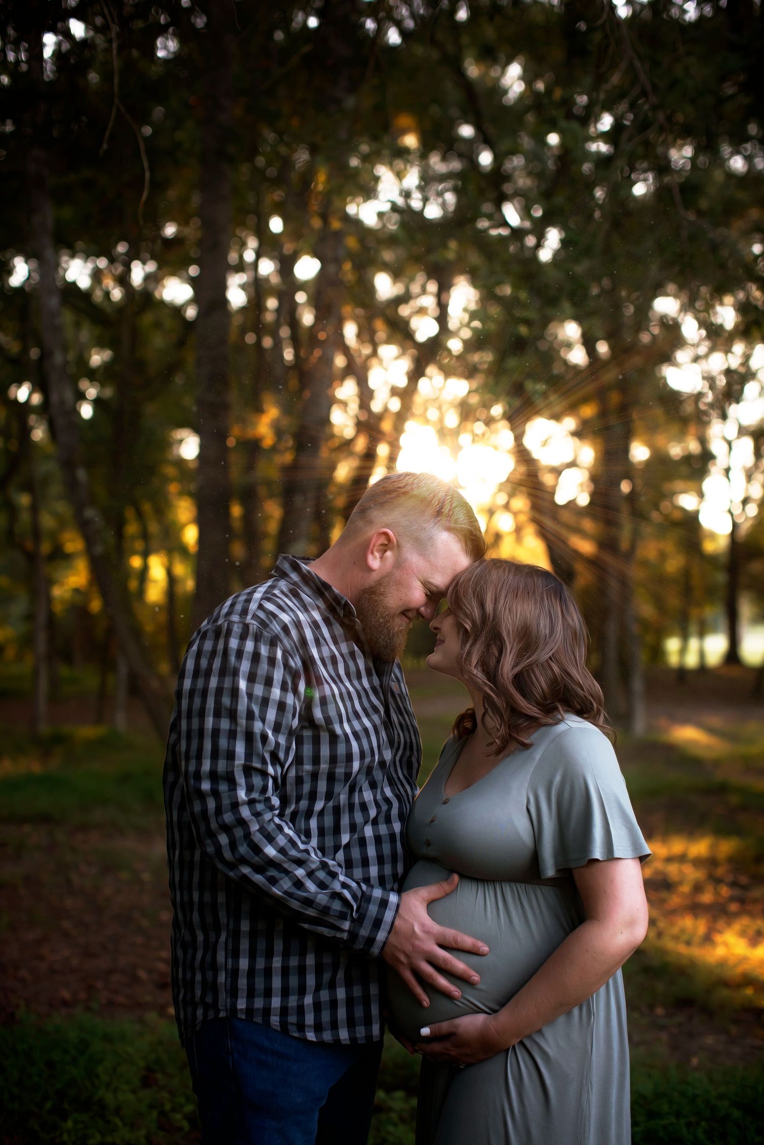 Romantic sunset photoshoot in a wooded park with golden hour lighting.