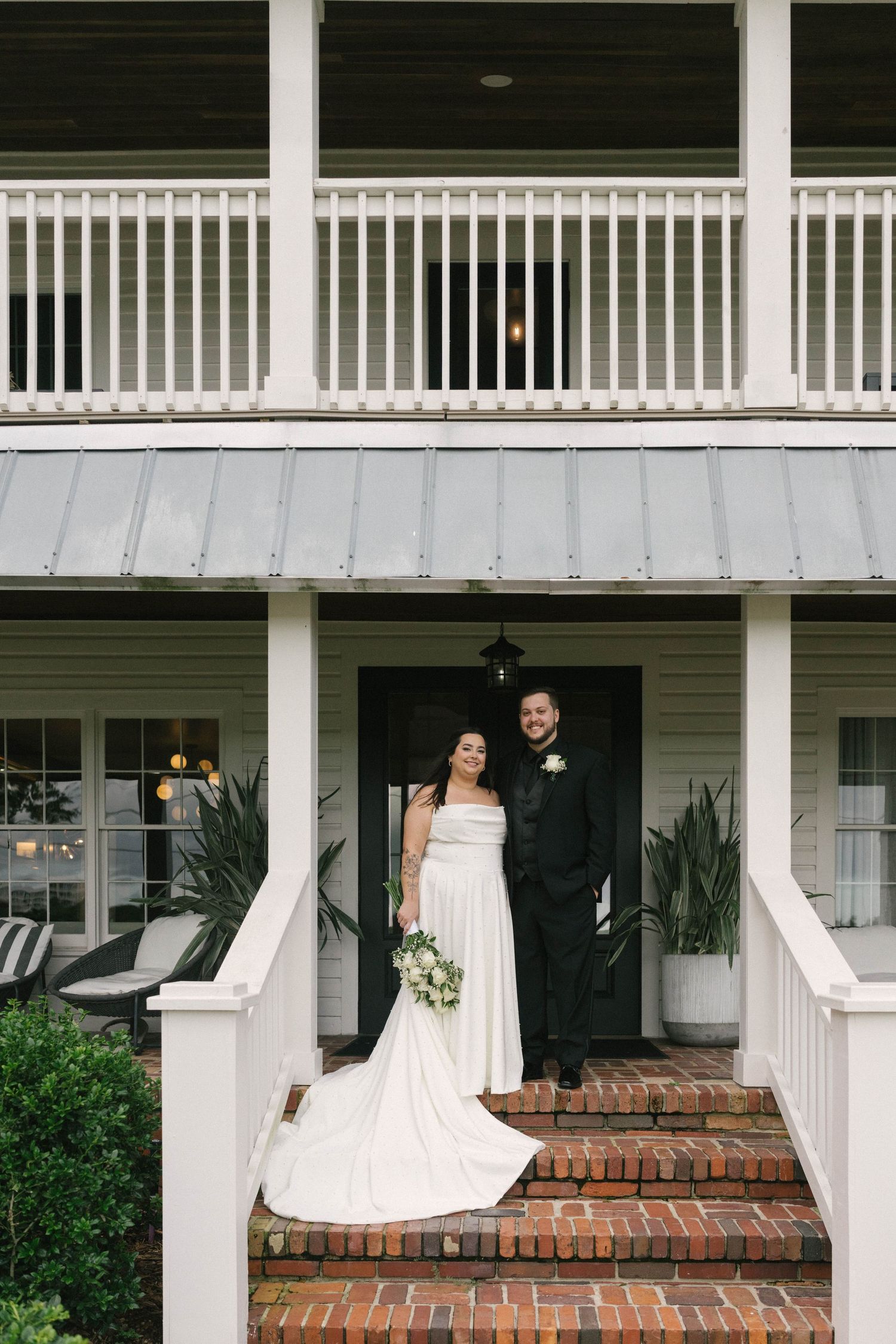 A sequence of four photos showing a bride and groom playfully peeking around white columns on a brick porch.
