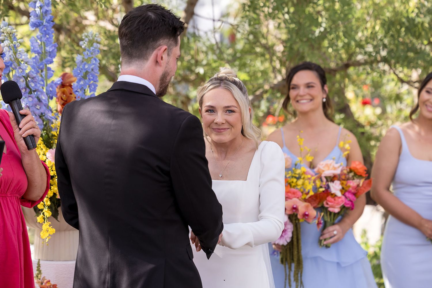 A Bride and Groom share a moment during their wedding vows during their outdoor wedding ceremony at the Balldale Hotel.