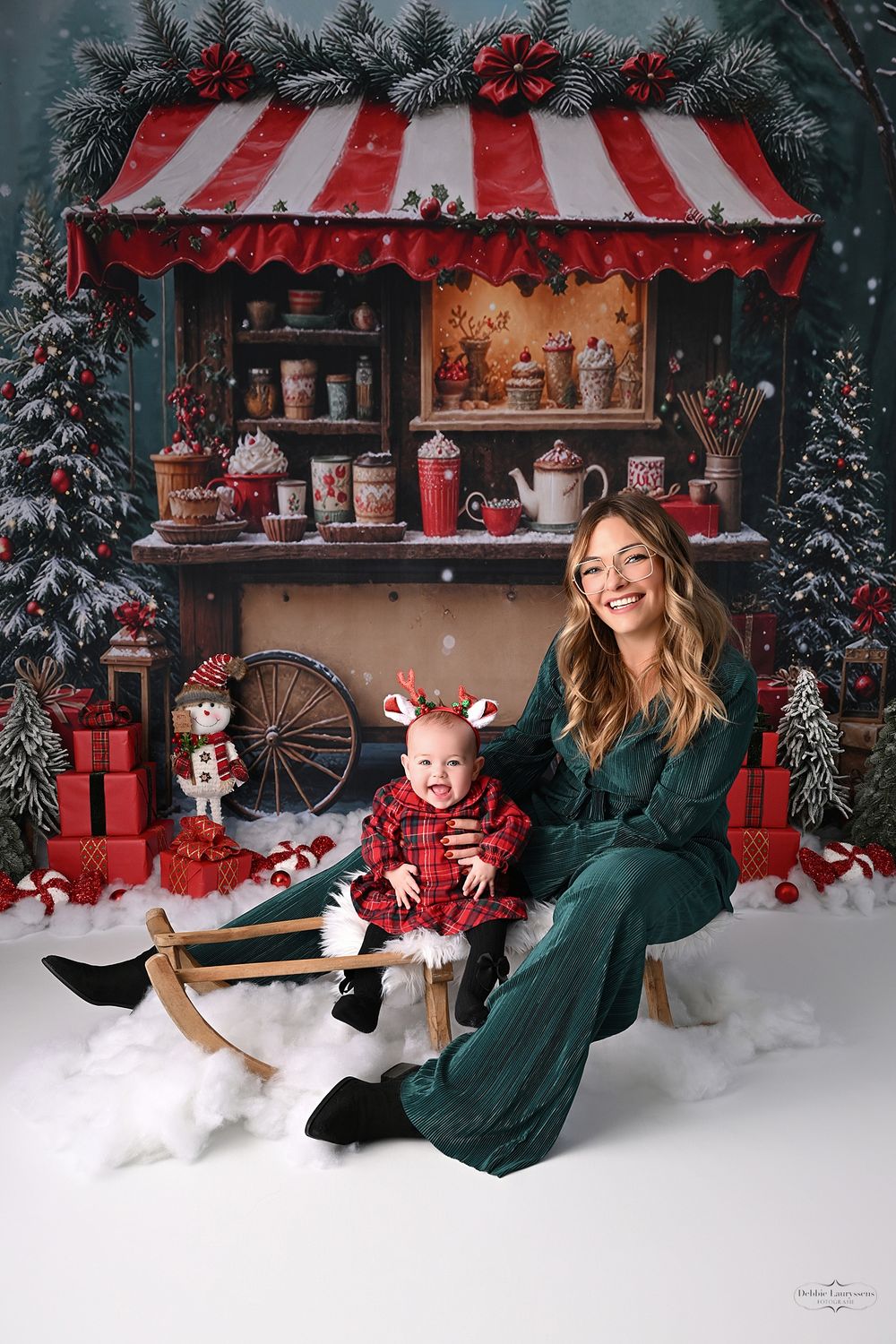 Christmas portrait session in front of a vintage-style holiday shop display with red and white striped awning.