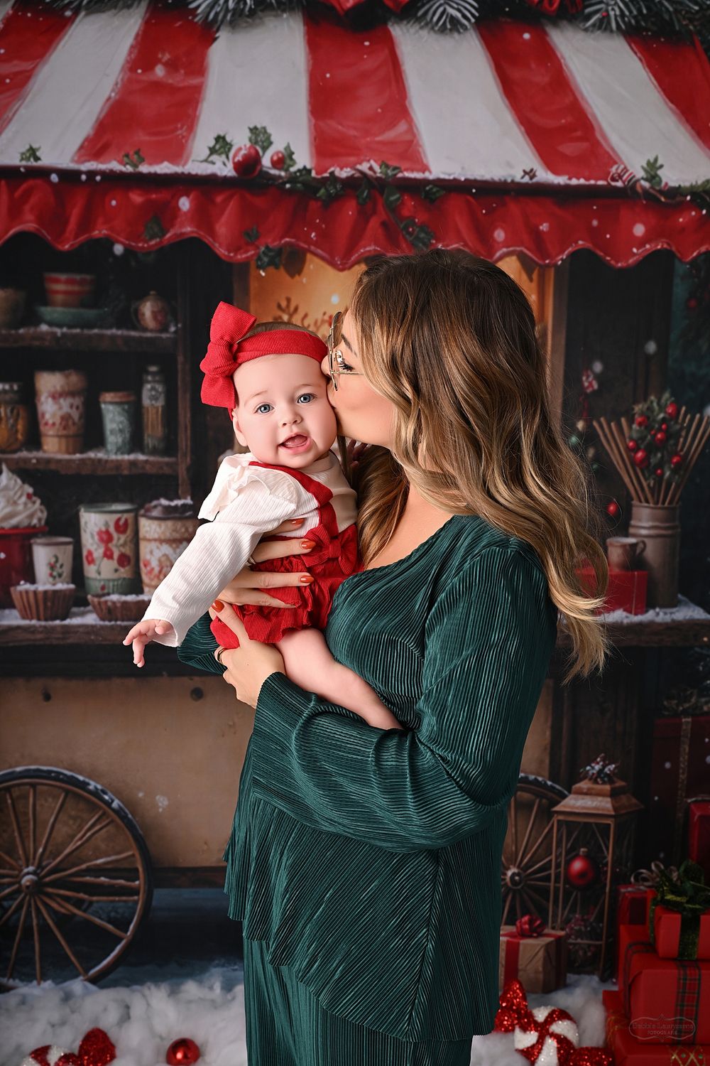 Playful Christmas photoshoot with red and white striped backdrop and vintage holiday decor.
