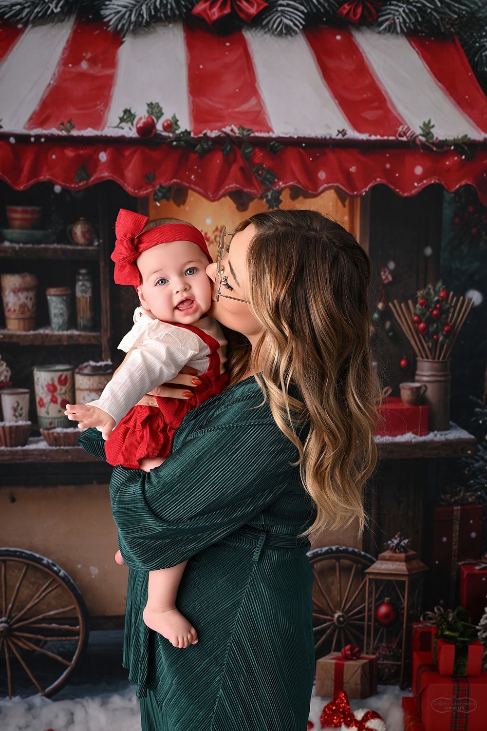 Sweet holiday moments captured against festive Christmas shop backdrop with snow and decorations.