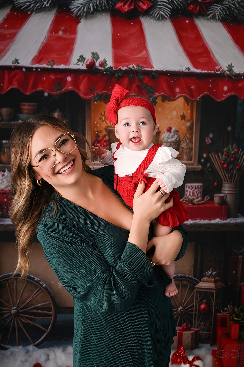 Candid Christmas portraits with vintage holiday shop display and red striped awning backdrop.