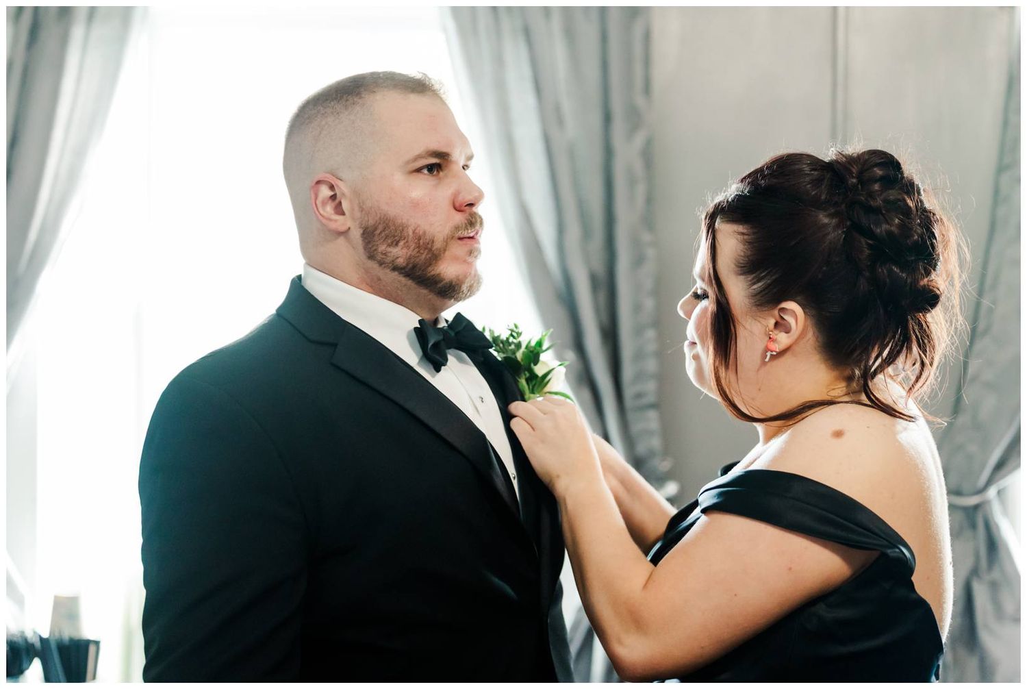 A touching moment between a couple in formal attire during a wedding celebration.