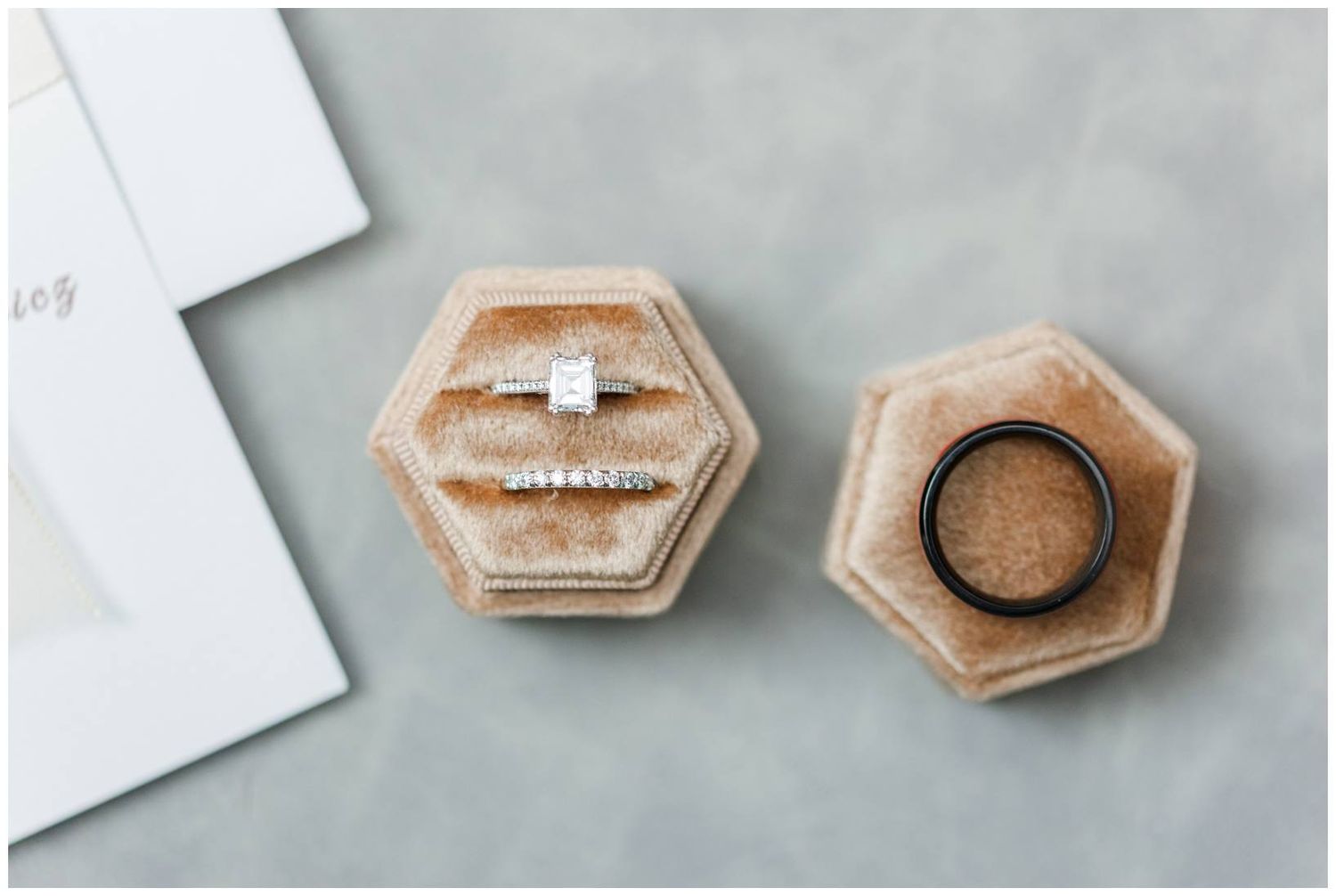 Hexagonal rose gold metallic jewelry boxes arranged in a minimalist composition against a light gray background.