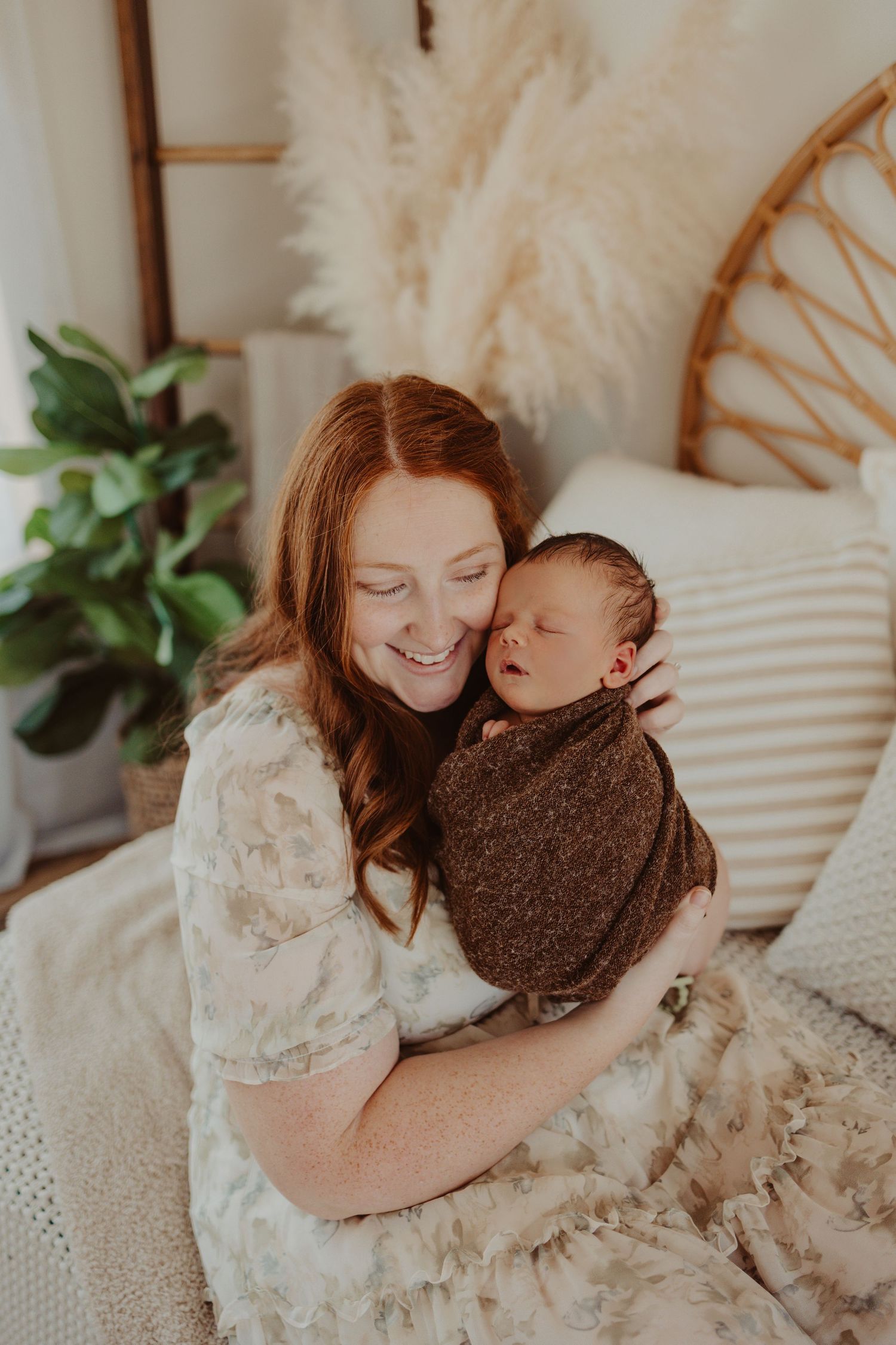 mother holding baby in cozy studio- newborn photography