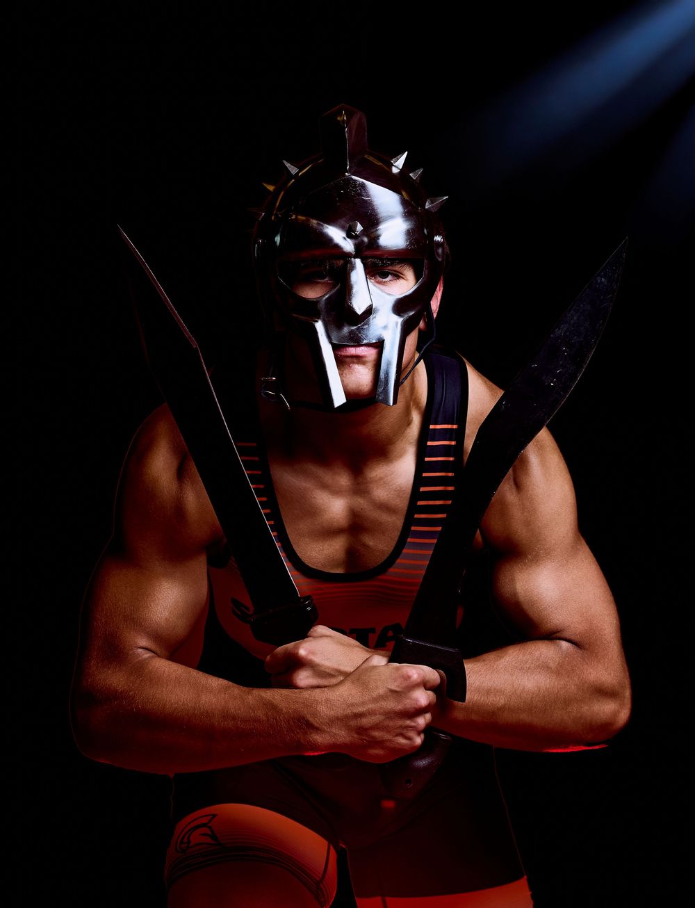 High school wrestler media-day style portrait with dramatic lighting — professional sports photography