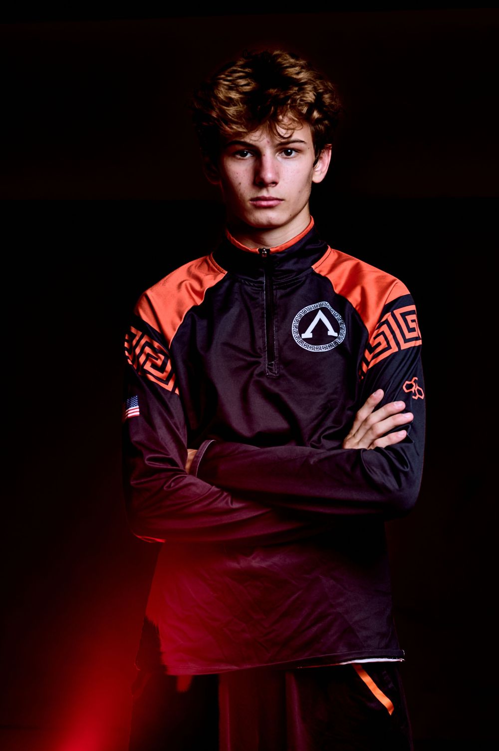 High school wrestler media-day style portrait with dramatic lighting — professional sports photography