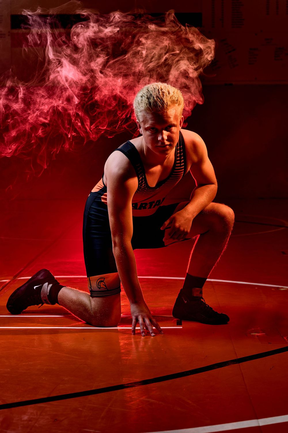 High school wrestler media-day style portrait with dramatic lighting — professional sports photography