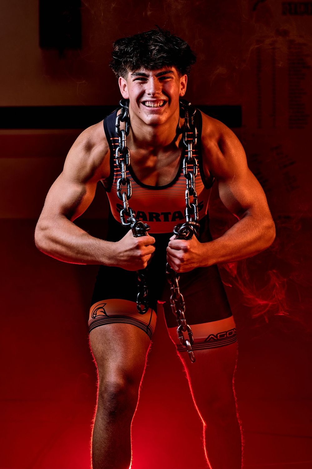 High school wrestler media-day style portrait with dramatic lighting — professional sports photography