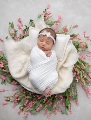 Peaceful sleeping newborn photographed in cozy home studio setting