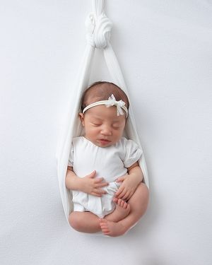 Peaceful sleeping newborn photographed in cozy home studio setting
