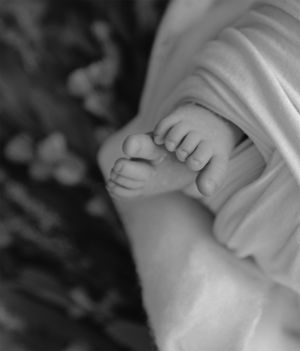 Newborn baby wrapped in neutral blanket during in-home studio session in San Diego