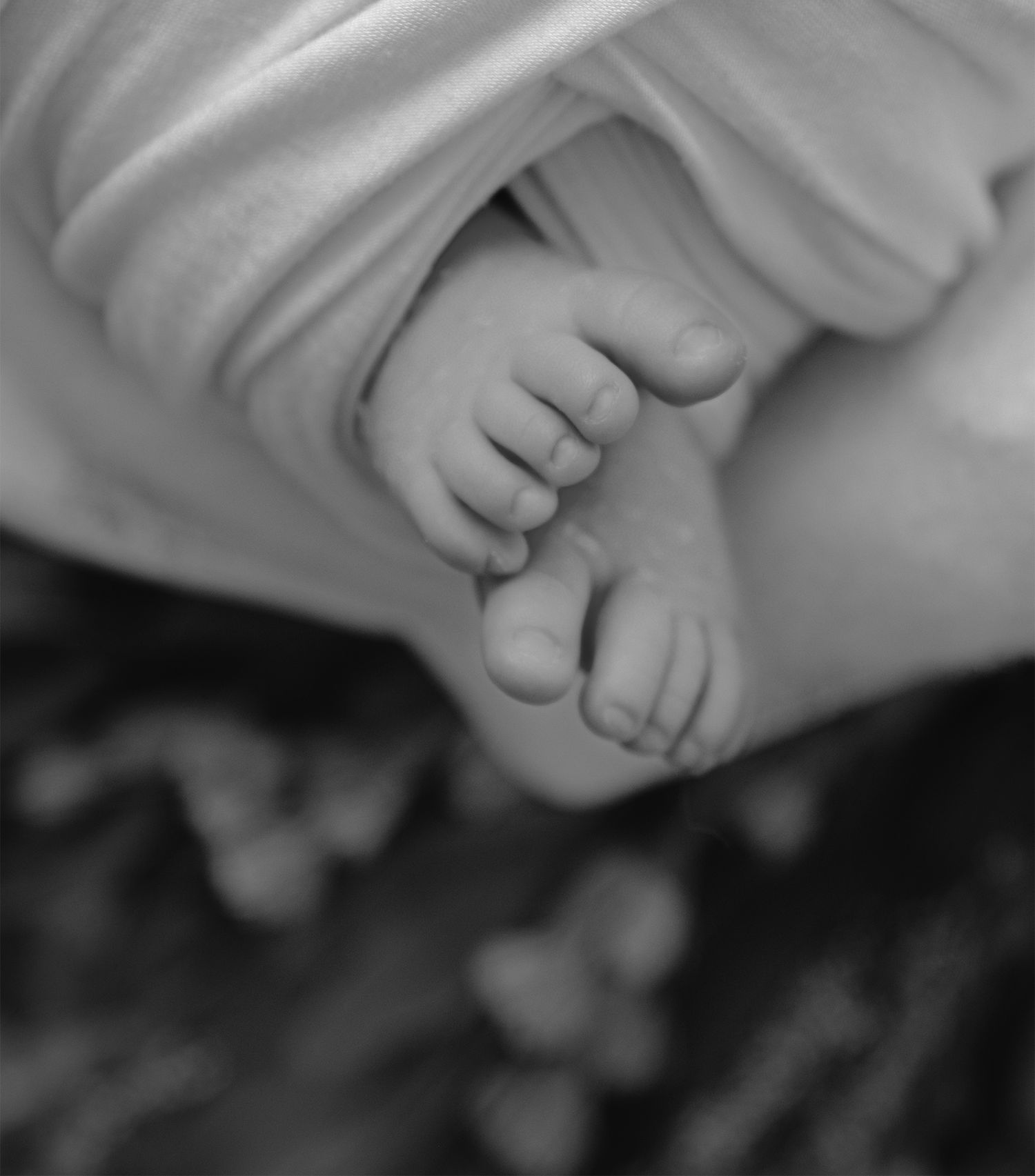 Newborn baby wrapped in neutral blanket during in-home studio session in San Diego