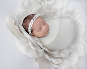 Newborn baby wrapped in neutral blanket during in-home studio session in San Diego