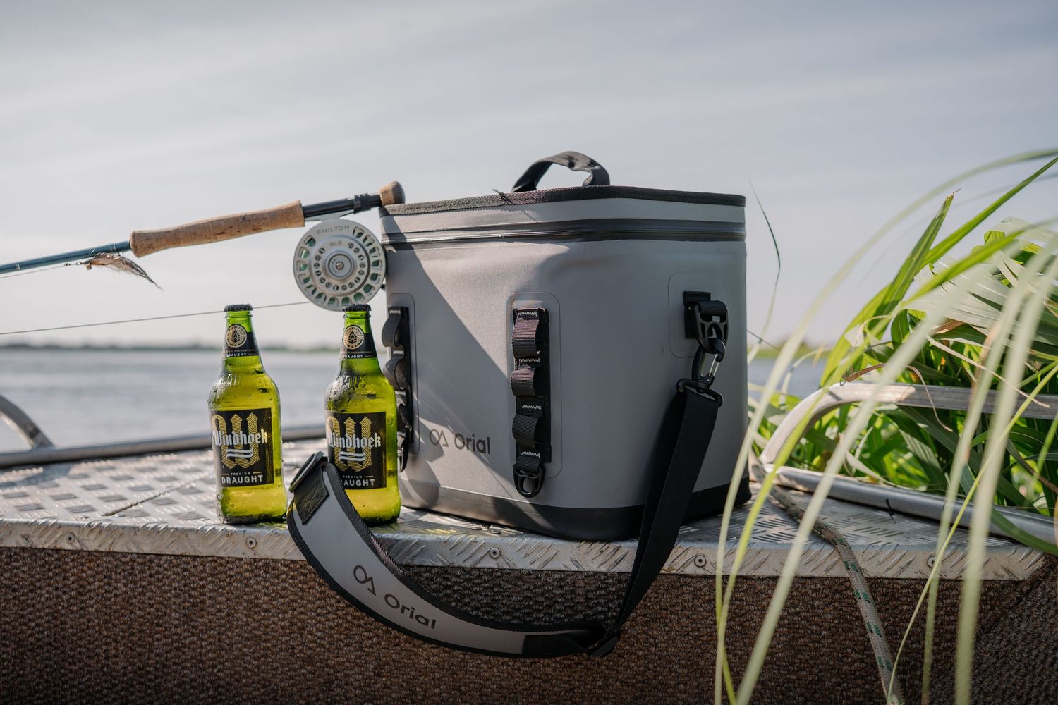 A collection of fishing reels and tackle gear arranged on a dark surface with selective focus.